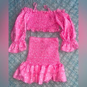 Two piece. Long sleeve top with snug but stretchy skirt. Pink w/ polka dots.